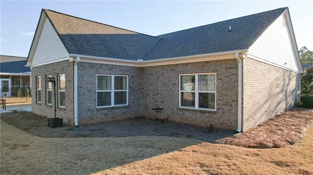 a view of house with backyard