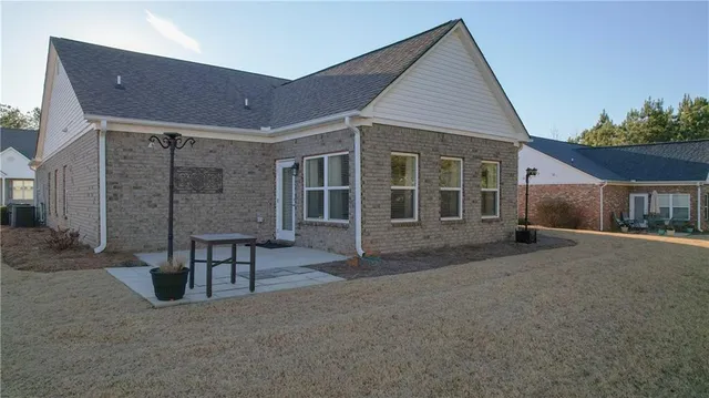 an aerial view of multiple houses with a yard