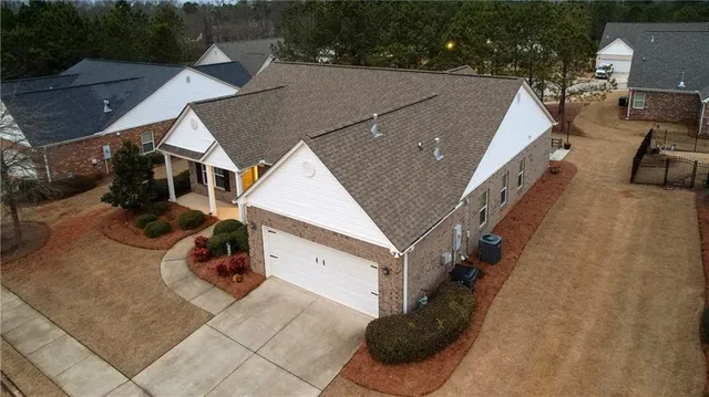 an aerial view of a house with a yard