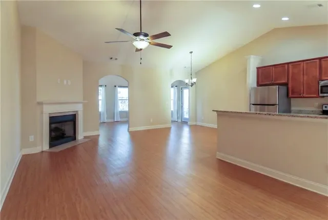 a view of a livingroom with a furniture wooden floor and a fireplace