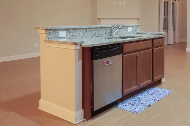a room with granite countertop cabinets and sink