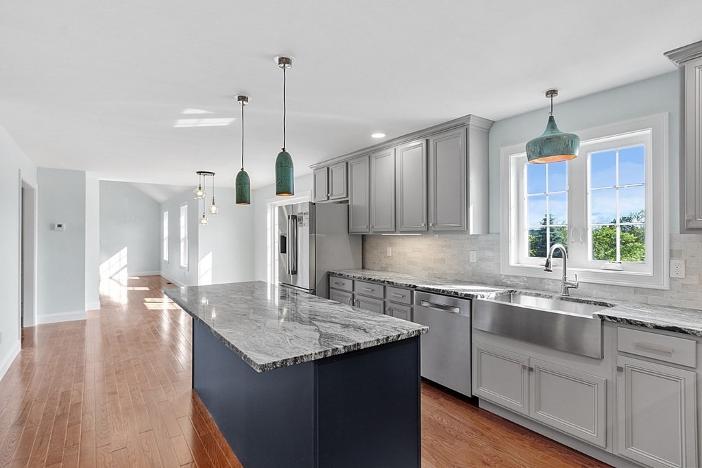 8 Worcester Road, Unit LOT 1 Westminster, MA 01473 - Photo 15 of 38 a kitchen with stainless steel appliances granite countertop a sink a stove a refrigerator and island with wooden floor
