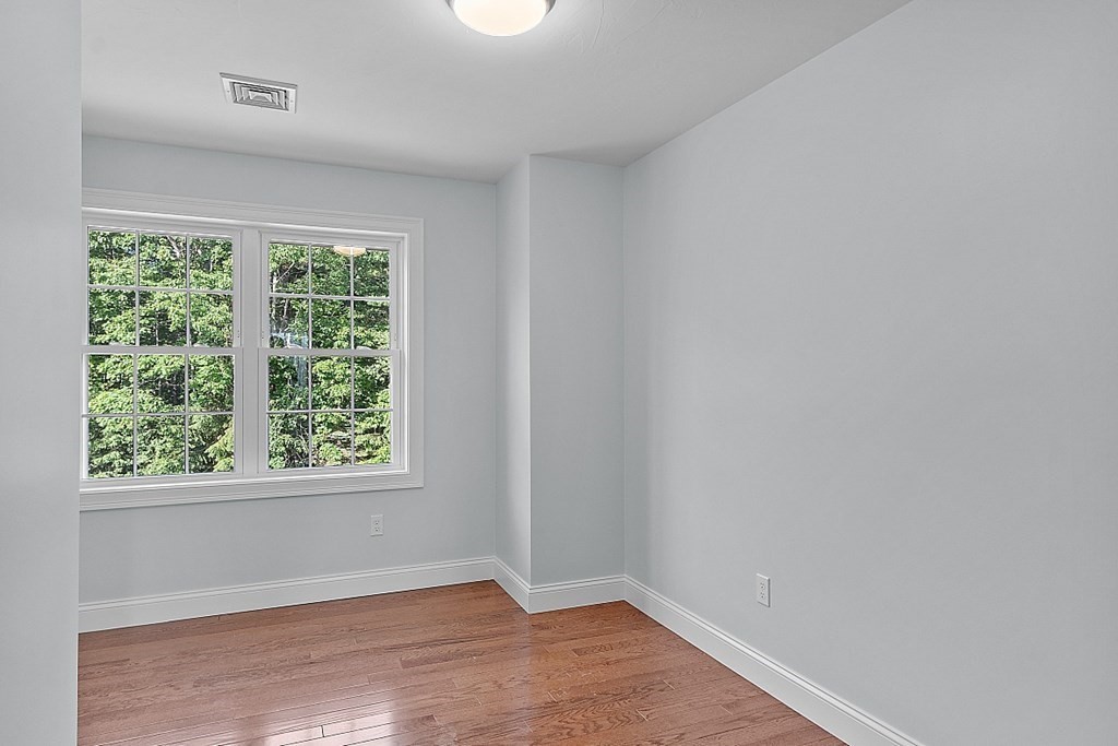 8 Worcester Road, Unit LOT 1 Westminster, MA 01473 - Photo 32 of 38 an empty room with wooden floor and windows