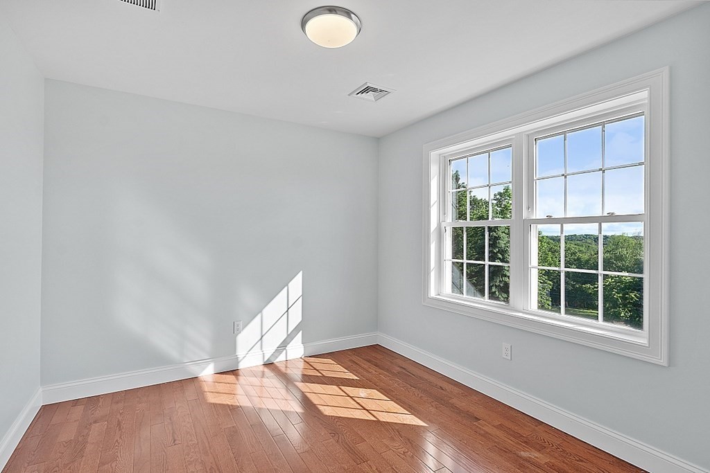 8 Worcester Road, Unit LOT 1 Westminster, MA 01473 - Photo 36 of 38 an empty room with wooden floor and windows