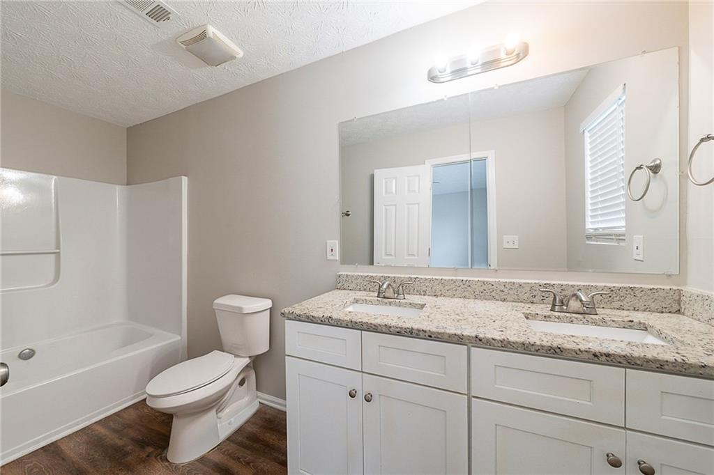 2183 Ramblewood Circle Decatur, GA 30035 - Photo 11 of 37 a bathroom with a granite countertop toilet sink and mirror