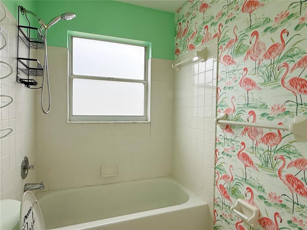 132 Robins Rest Circle Davenport, FL 33896 - Photo 19 of 35 a bathroom with a bathtub and a shower curtain