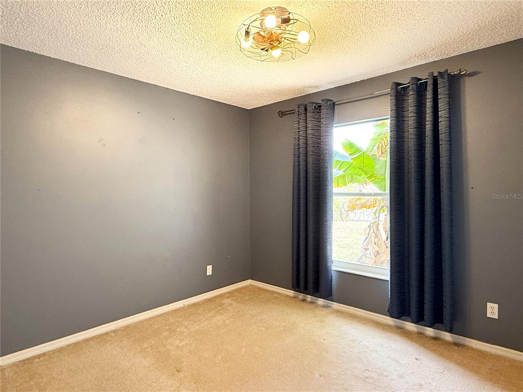 132 Robins Rest Circle Davenport, FL 33896 - Photo 25 of 35 a view of an empty room and a window