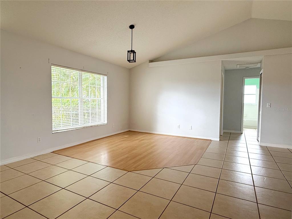 132 Robins Rest Circle Davenport, FL 33896 - Photo 5 of 35 an empty room with windows and painted walls
