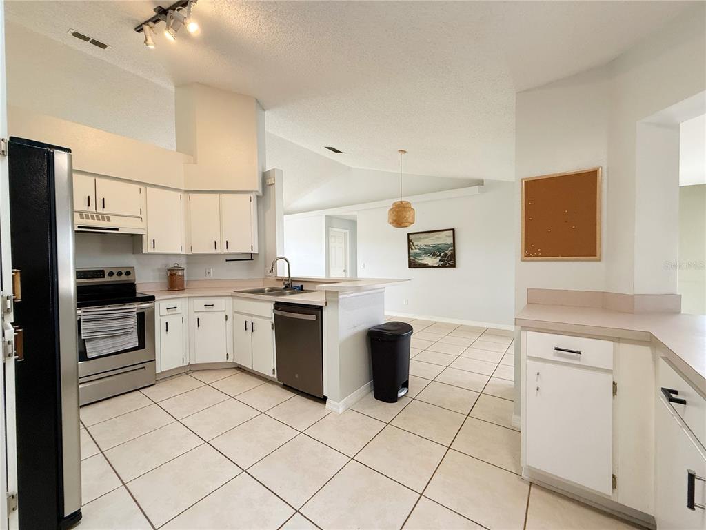 132 Robins Rest Circle Davenport, FL 33896 - Photo 8 of 35 a kitchen with a sink appliances and cabinets