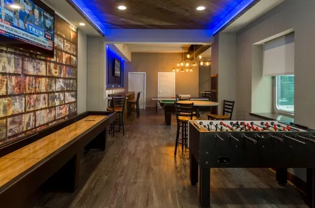 a kitchen with sink refrigerator dining table and chairs