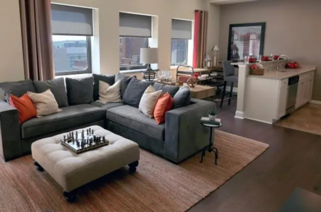 a living room with furniture and a large window