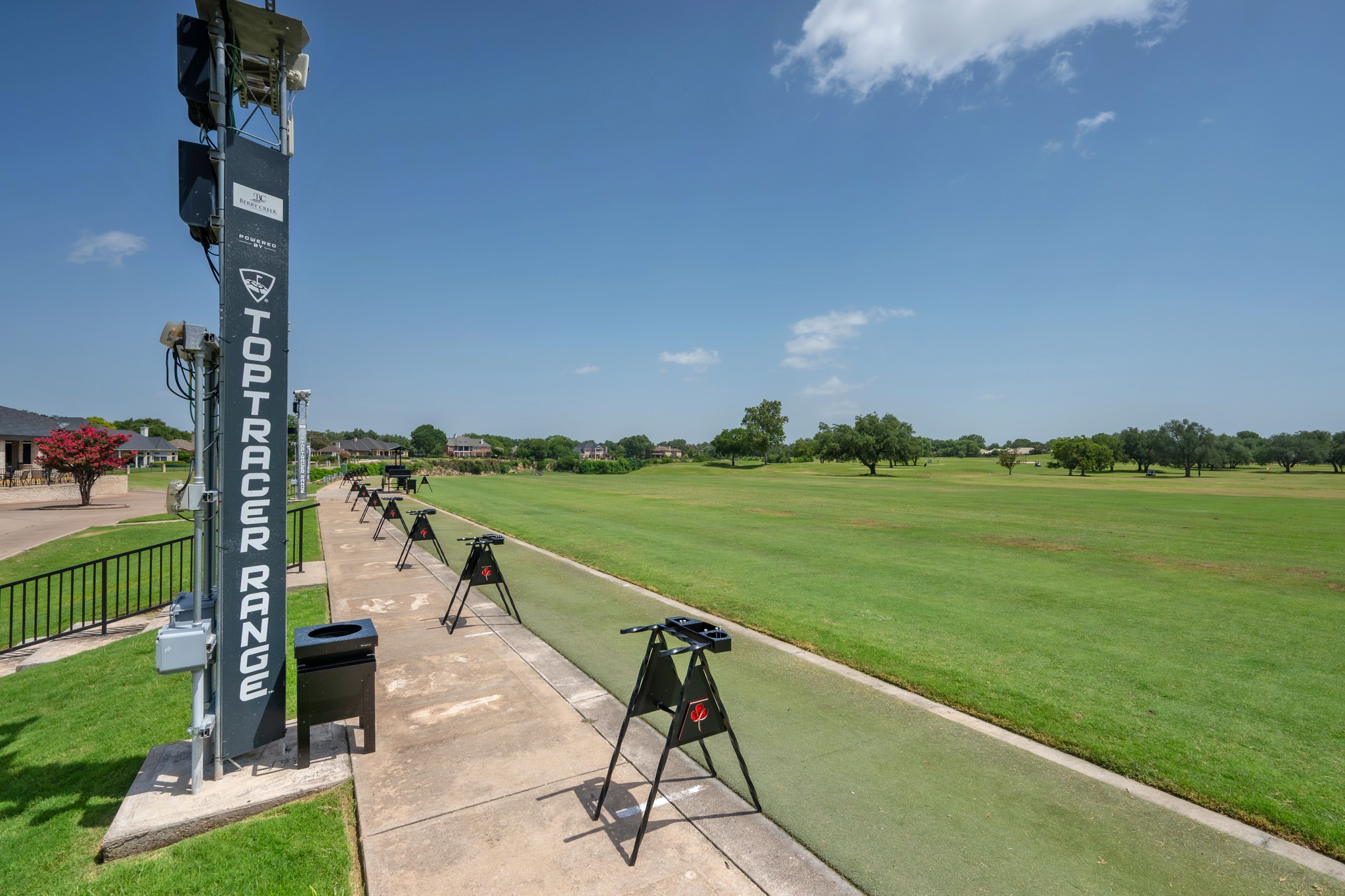 30115 Sawgrass Trail Georgetown, TX 78628 - Photo 31 of 37 An inviting driving range awaits golfers, offering a chance to refine their swing amidst lush green landscapes and open skies.