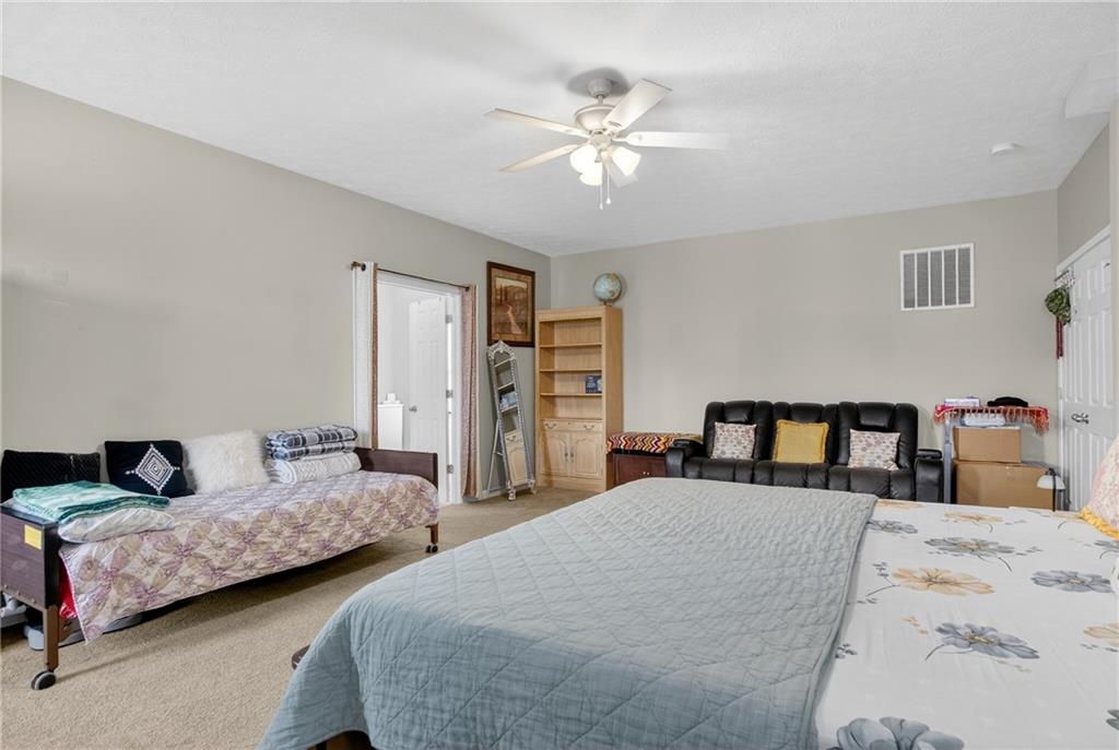423 Labrador Lane Clairton, PA 15025 - Photo 23 of 49 a bedroom with two large bed and a chandelier