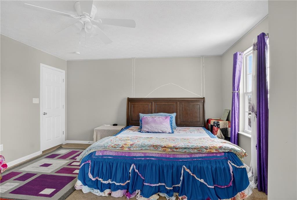 423 Labrador Lane Clairton, PA 15025 - Photo 33 of 49 a bedroom with a bed and wooden floor