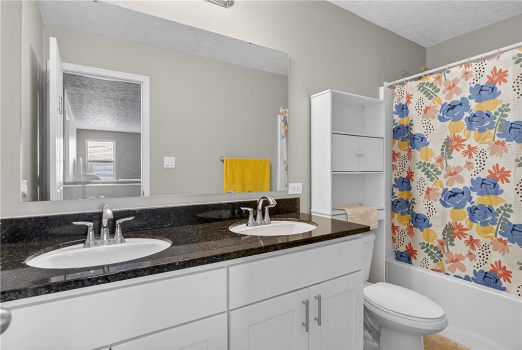 423 Labrador Lane Clairton, PA 15025 - Photo 34 of 49 a bathroom with a granite countertop sink and a mirror with toilet