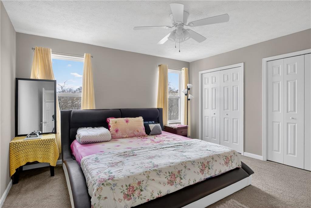 423 Labrador Lane Clairton, PA 15025 - Photo 35 of 49 a bedroom with a bed and a chandelier