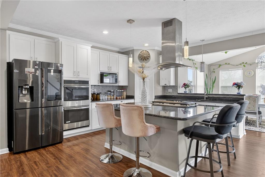 423 Labrador Lane Clairton, PA 15025 - Photo 8 of 49 a kitchen with stainless steel appliances a dining table chairs stove and sink