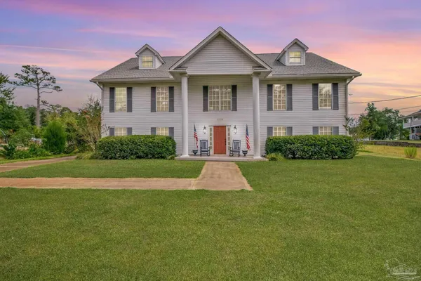 a front view of a house with a yard