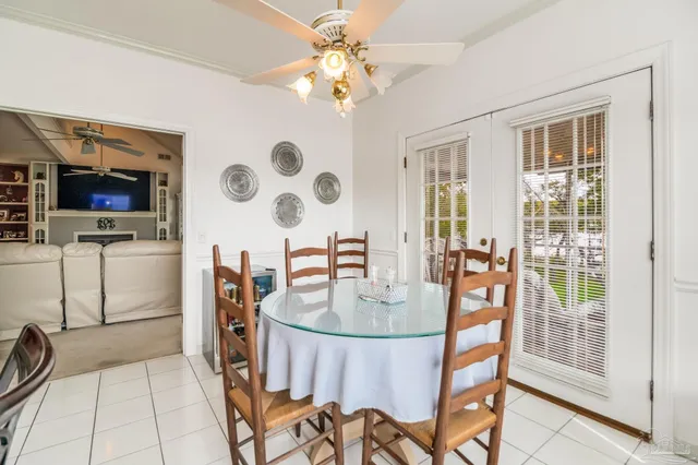 a dining room with furniture a livingroom a chandelier and wooden floor