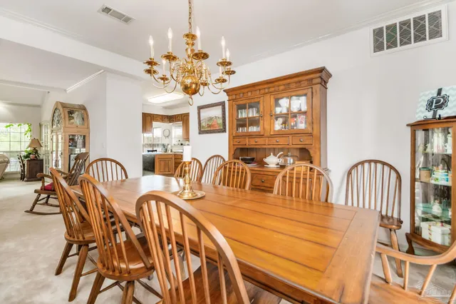 a view of a dining room with furniture and chandelier