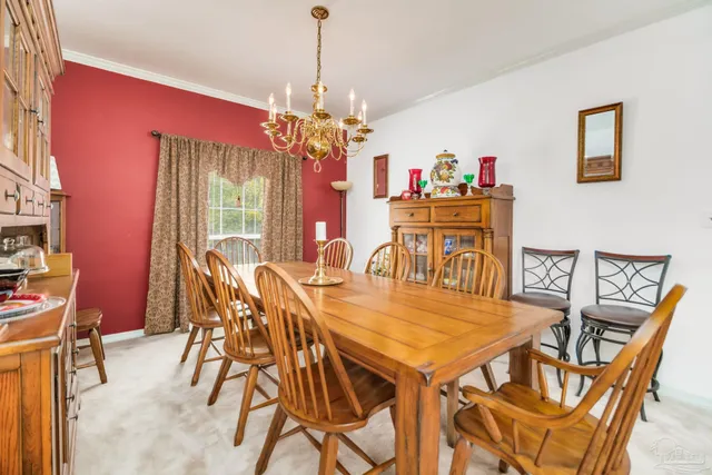 a spacious bedroom with a bed and a chandelier