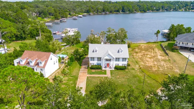 an aerial view of a house with garden space and lake view