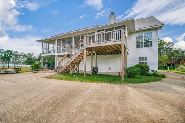a view of a house with a backyard and porch