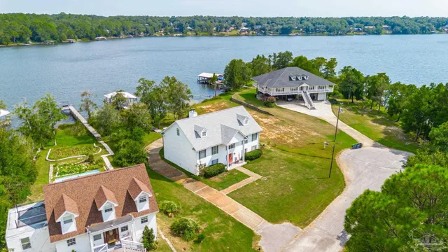 an aerial view of a house with a lake view