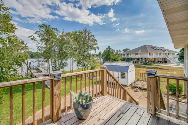 a room with pool table and windows