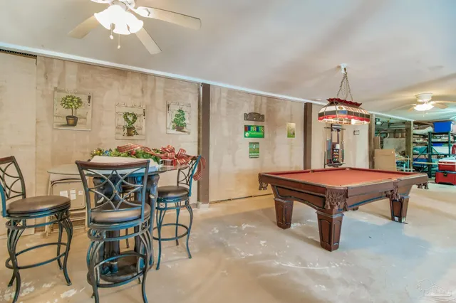 a living room with patio furniture and a floor to ceiling window