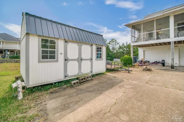 a view of house with garden and lake view