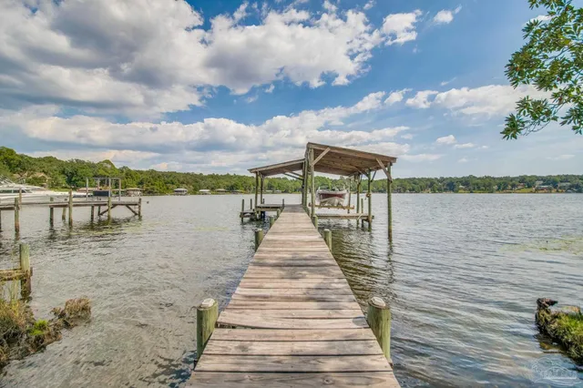 a room with pool table and chairs