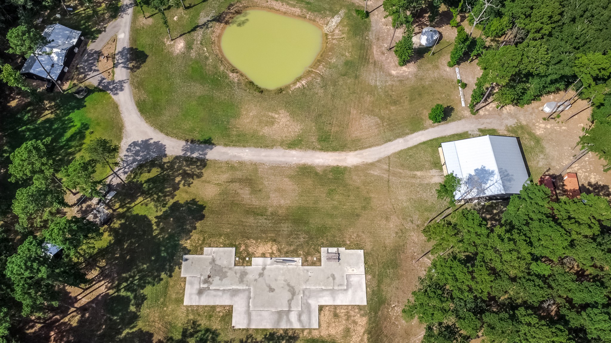 6409 Medley Road New Waverly, TX 77358 - Photo 45 of 50 This foundation is ready for you to make it whatever you want! It was poured with intent to build a 4,250sf dog run style home, but unfortunately it has not been completed. A dog run style of home has the main living area and primary bed and bath separated from the secondary bedrooms by a screened porch. This gives the homeowner a true sense of privacy from the other occupants or allows them to only cool/heat the secondary side as needed. The full plans are available.