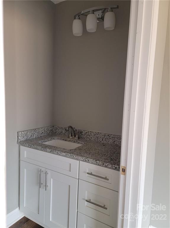 1152 Blacksnake Road Stanley, NC 28164 - Photo 12 of 15 a bathroom with a granite countertop sink and vanity