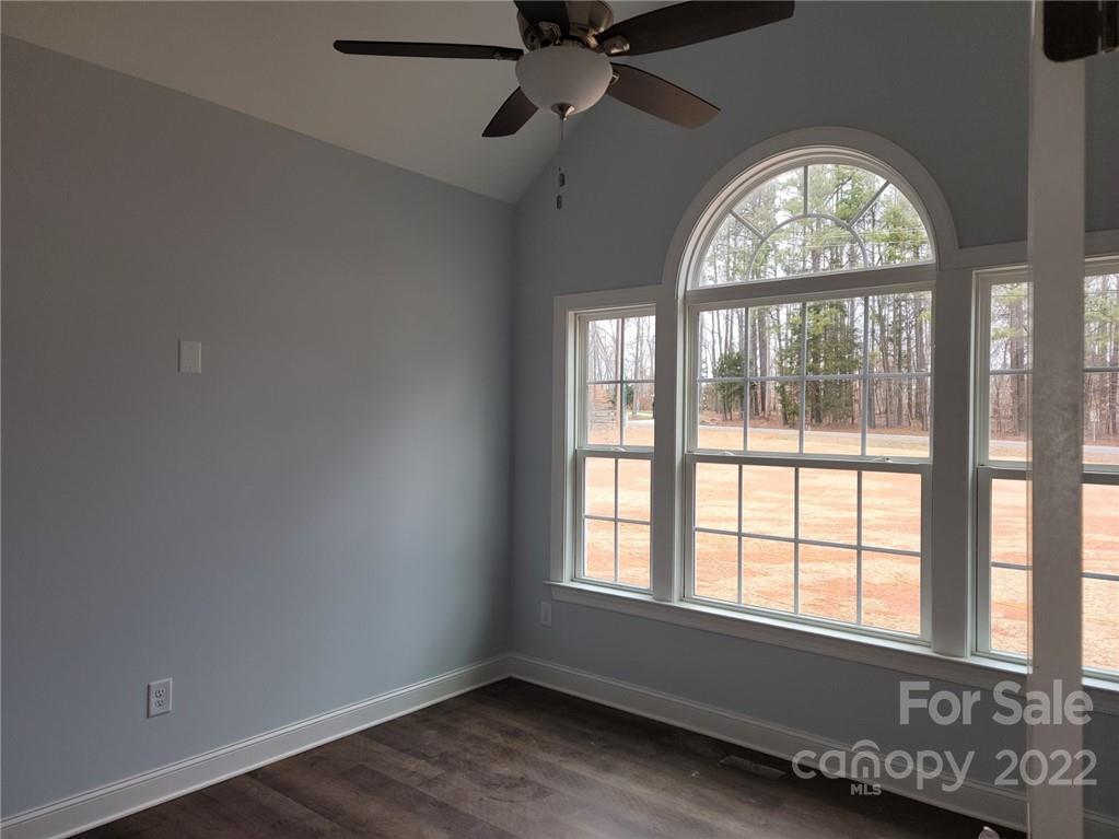 1152 Blacksnake Road Stanley, NC 28164 - Photo 13 of 15 an empty room with wooden floor fan and windows