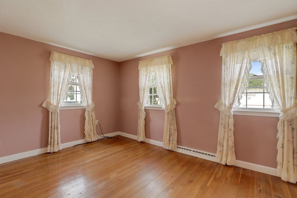 48 Maynard Street Boston, MA 02131 - Photo 12 of 23 an empty room with wooden floor and windows
