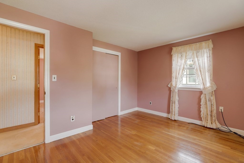 48 Maynard Street Boston, MA 02131 - Photo 13 of 23 an empty room with wooden floor and windows