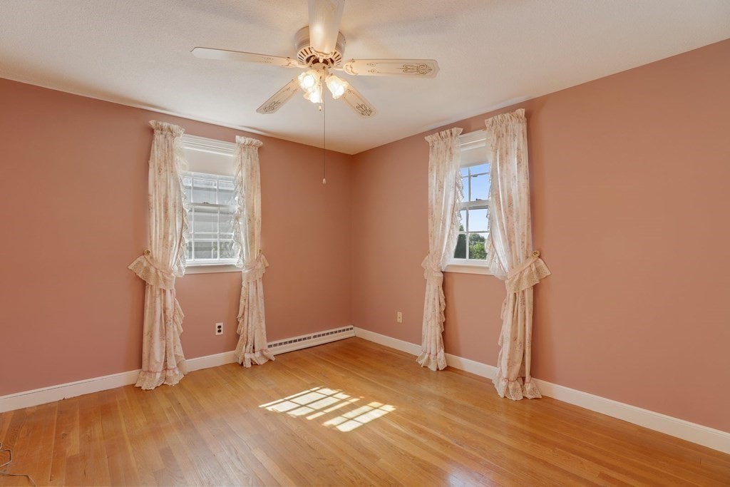 48 Maynard Street Boston, MA 02131 - Photo 14 of 23 an empty room with wooden floor and windows