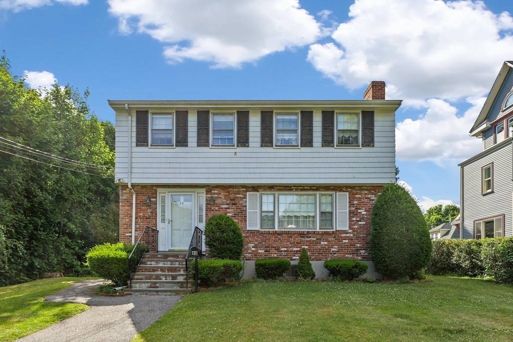 48 Maynard Street Boston, MA 02131 - Photo 22 of 23 a front view of a house with a garden and plants