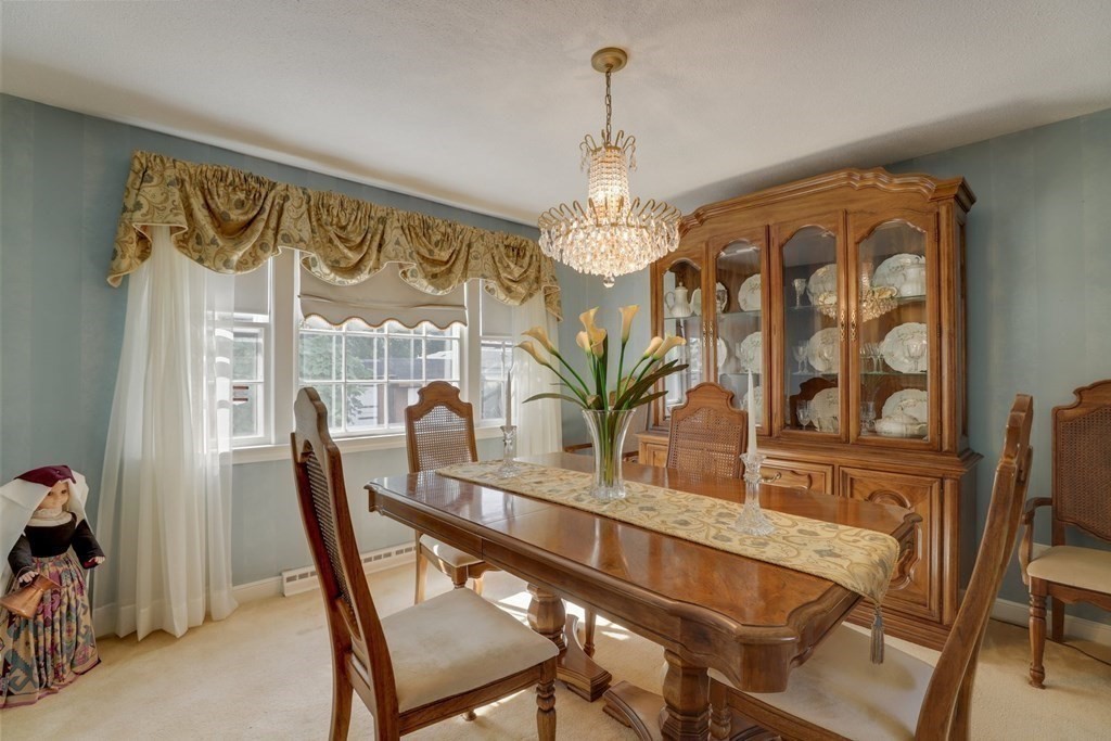 48 Maynard Street Boston, MA 02131 - Photo 4 of 23 a dining room with furniture a chandelier and wooden floor