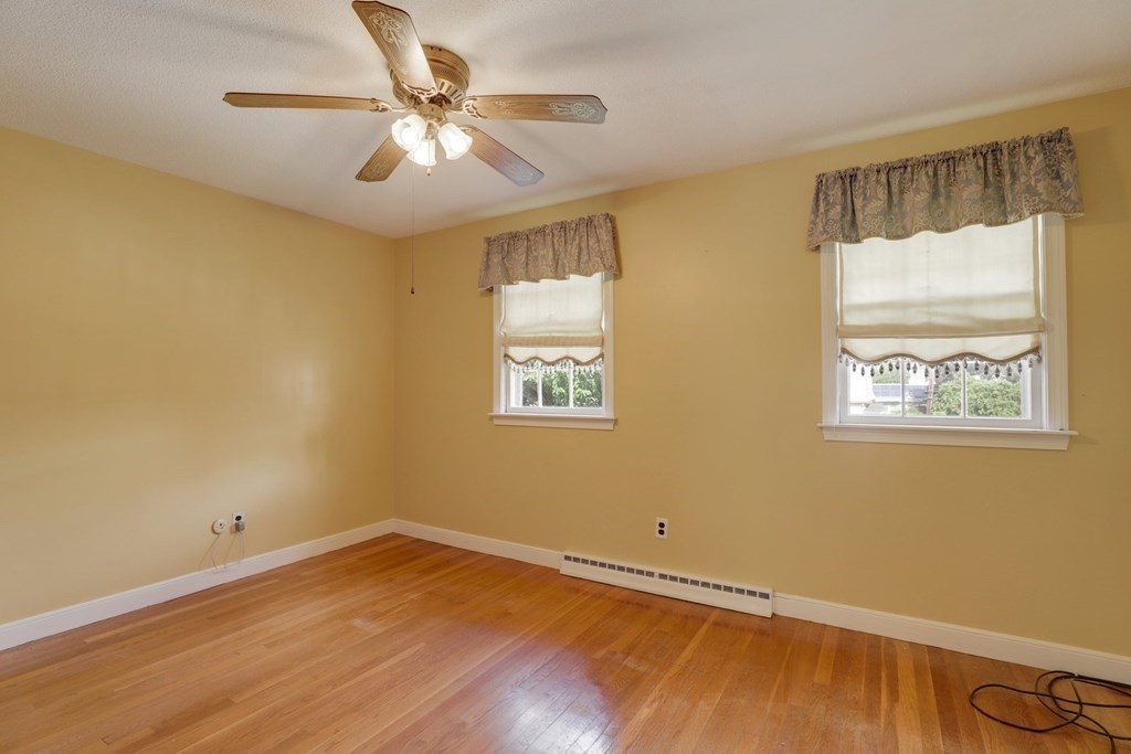 48 Maynard Street Boston, MA 02131 - Photo 10 of 23 a view of an empty room with window and wooden floor