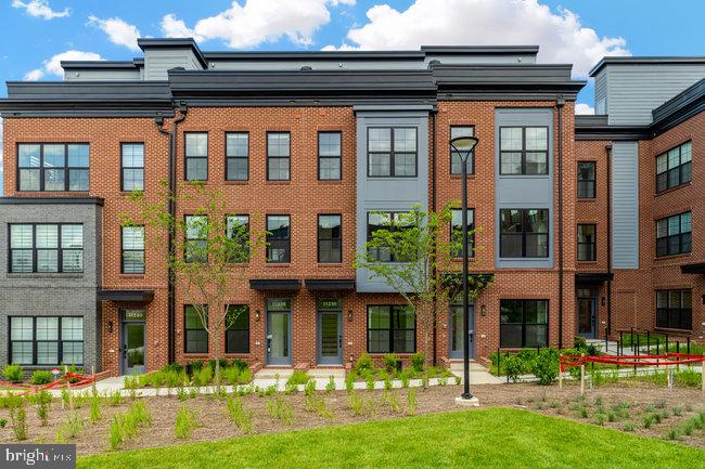 Modern townhomes with lush landscaping.