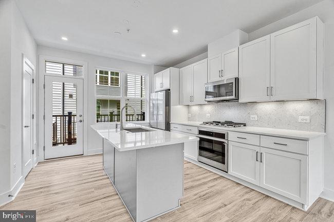 11236 Bunsen Street Reston, VA 20190 - Photo 14 of 61 Modern kitchen with sleek finishes.