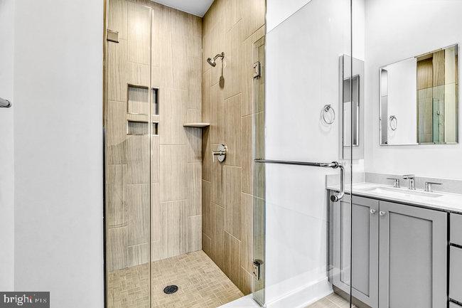 11236 Bunsen Street Reston, VA 20190 - Photo 30 of 61 Sleek modern shower with elegant tiles.