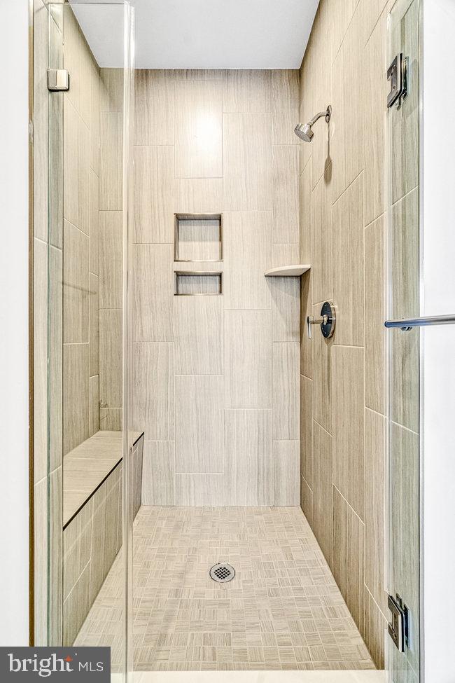 11236 Bunsen Street Reston, VA 20190 - Photo 31 of 61 Sleek modern shower with elegant tiles.