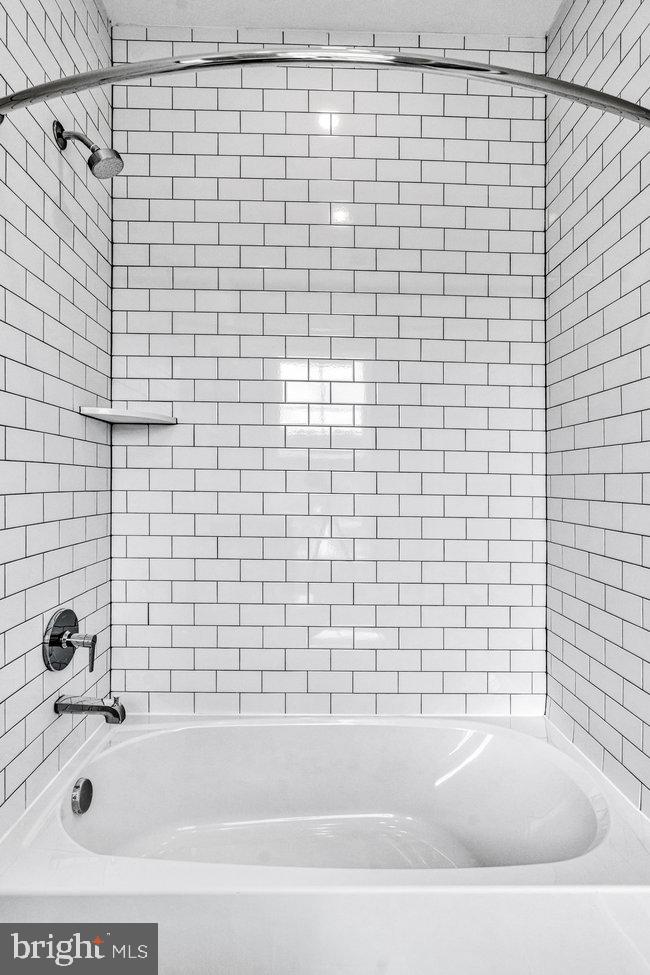 11236 Bunsen Street Reston, VA 20190 - Photo 37 of 61 Sleek subway tile shower retreat.