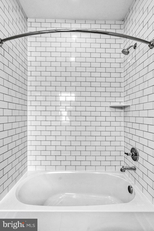 11236 Bunsen Street Reston, VA 20190 - Photo 41 of 61 Sleek, modern tiled shower retreat.