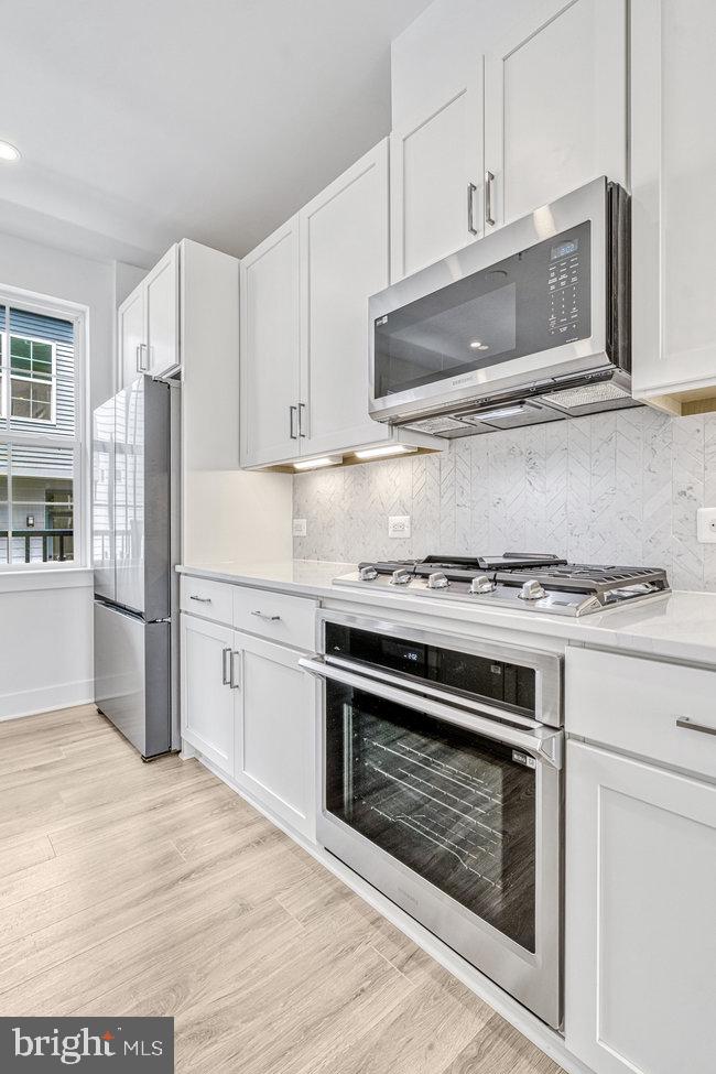 11236 Bunsen Street Reston, VA 20190 - Photo 54 of 61 Sleek modern kitchen with elegance.