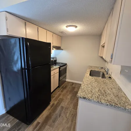 a kitchen with a refrigerator and a sink