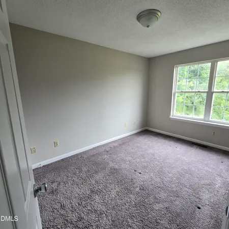 an empty room with a empty space and window